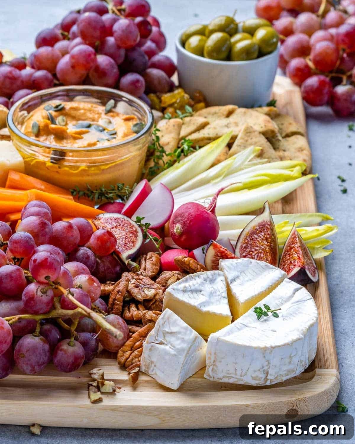 A Symphony of Flavors Fruit and Cheese 4 A festive holiday platter brimming with an assortment of cheeses, vibrant fruits, crunchy nuts, and fresh vegetables, perfect for entertaining.