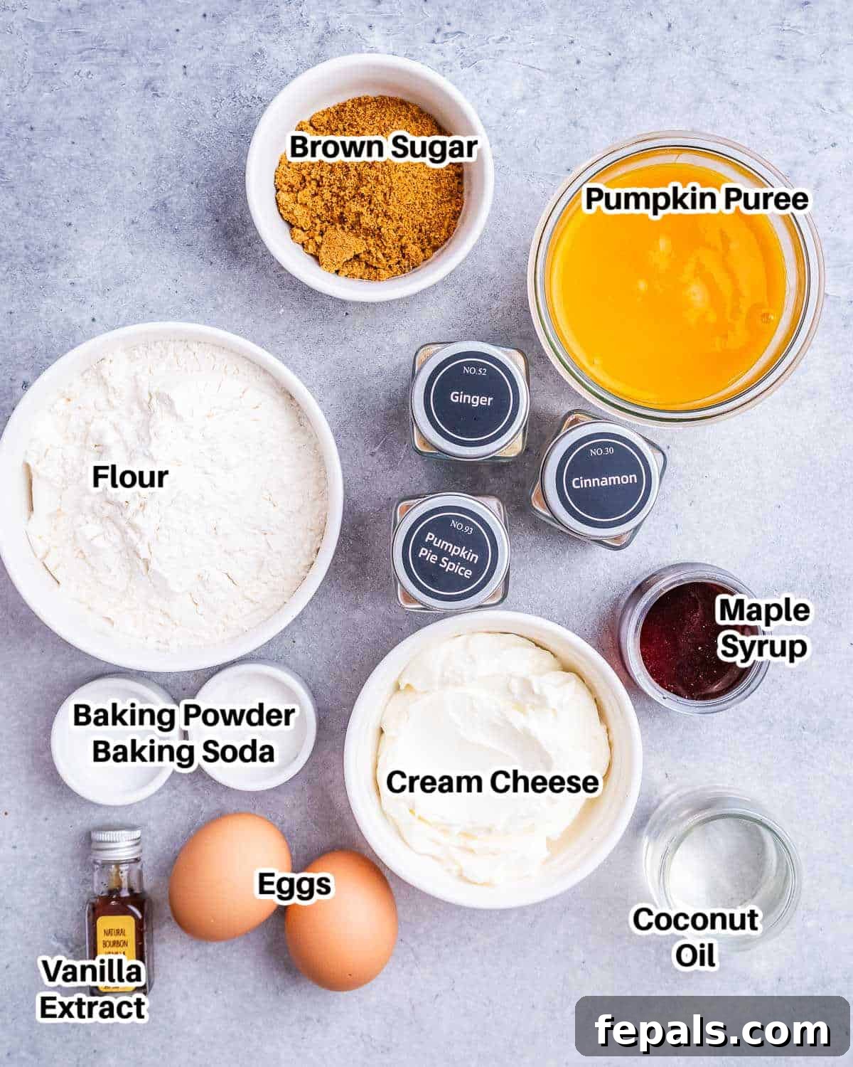 Spiced Pumpkin Cream Cheese Swirl Muffins 3 Various ingredients for making pumpkin cream cheese muffins, including pumpkin puree, spices, flour, eggs, and cream cheese, arranged on a rustic surface.