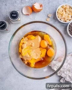 Wet ingredients for pumpkin batter mixed in a bowl.
