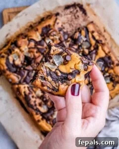 hand holding a piece of pumpkin brownie.