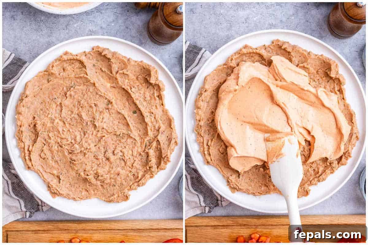 spreading the bean dip layer on a plate.