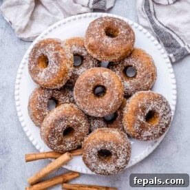 pumpkin donuts on a white plate, ready to be served.