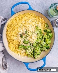 Broccoli being added to orzo