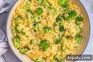Broccoli cheddar orzo in a pan, ready to serve.