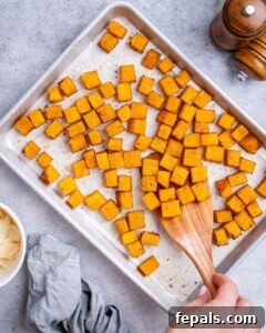 Savory Butternut Squash & Beef Ragu Pasta 10 Cubed butternut squash spread evenly on a baking sheet, ready to roast.