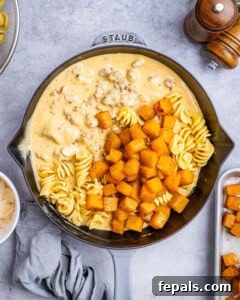 Savory Butternut Squash & Beef Ragu Pasta 14 Cooked pasta, roasted butternut squash, and sauce together in a skillet, ready to mix.