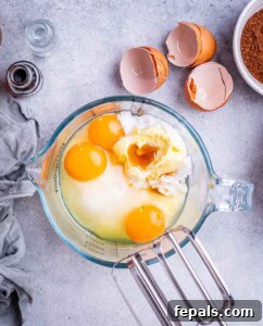 Mixing bowl with butter, sugar, eggs, and coconut oil before beating together for the brownie batter.