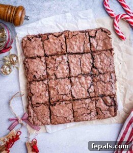 Freshly baked and sliced peppermint brownies resting on parchment paper.