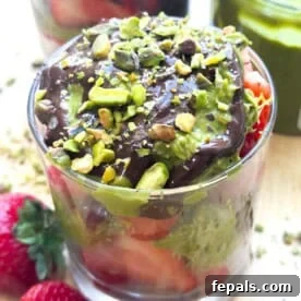 A beautifully layered cup filled with fresh strawberries, crunchy pistachio cream Kataifi, melted chocolate, and topped with crushed pistachios.