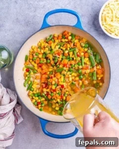 Vibrant Veggie Mac 10 Sauteing onion and adding veggies to a pan
