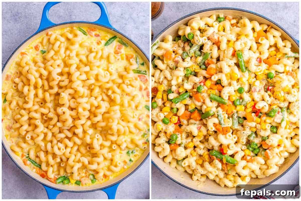 Vibrant Veggie Mac 6 Process shot showing the half-cooked macaroni being added to the creamy cheese and vegetable sauce in a skillet, ready to be combined.