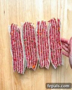 tortilla layered with beef facing up, showing the layers.
