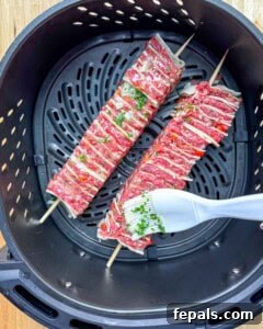 Basting the tortilla kebab in the air fryer.