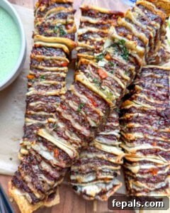 air fried tortilla kebabs stacked on a wooden board.