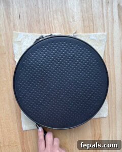 A round pan placed over puff pastry as a guide for cutting a perfect circle.