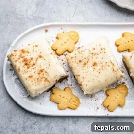 Two squares of Gingerbread Cake, beautifully frosted and arranged on a plate.