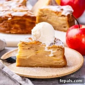 A delicate slice of Invisible Apple Cake on a plate, revealing its custardy texture.