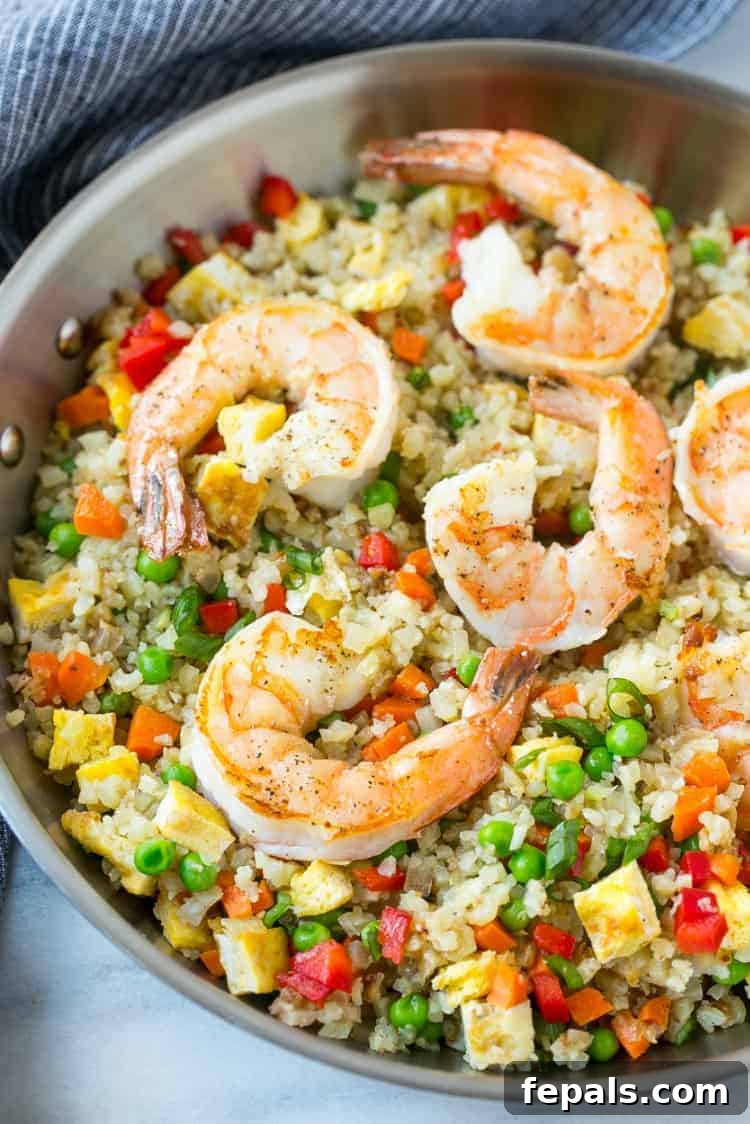 Shrimp Cauliflower Fried Rice: Your Ultimate Low-Carb Dinner Solution Delicious and healthy cauliflower fried rice with shrimp and vegetables in a pan, ready to serve.
