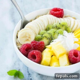 Fruit and Oatmeal Breakfast in a round white bowl, ready for serving.
