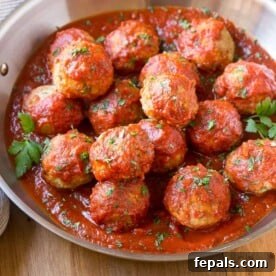 turkey meatballs in a bowl with tomato sauce.
