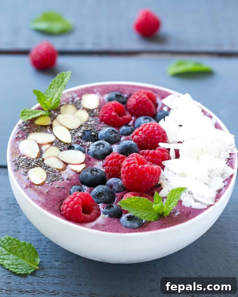 Berry Burst Bowl 5 A delightful side shot of a richly textured smoothie bowl, generously topped with an assortment of fresh, vibrant berries, creating an inviting and healthy breakfast.