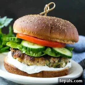 One turkey feta burger with lettuce, cucumber, tomato, and tzatziki sauce