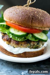 One turkey feta spinach burger with cucumber, lettuce, tomato, and tzatziki sauce