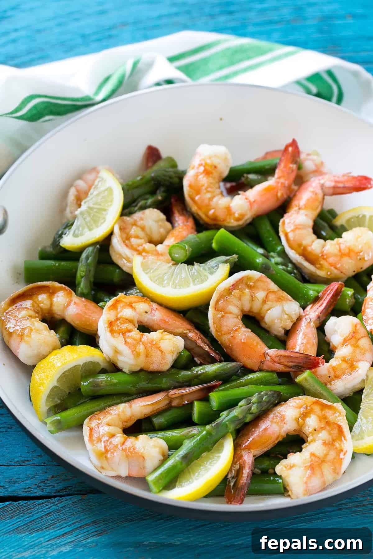 Lemon Asparagus Shrimp on a plate, garnished with lemon wedges