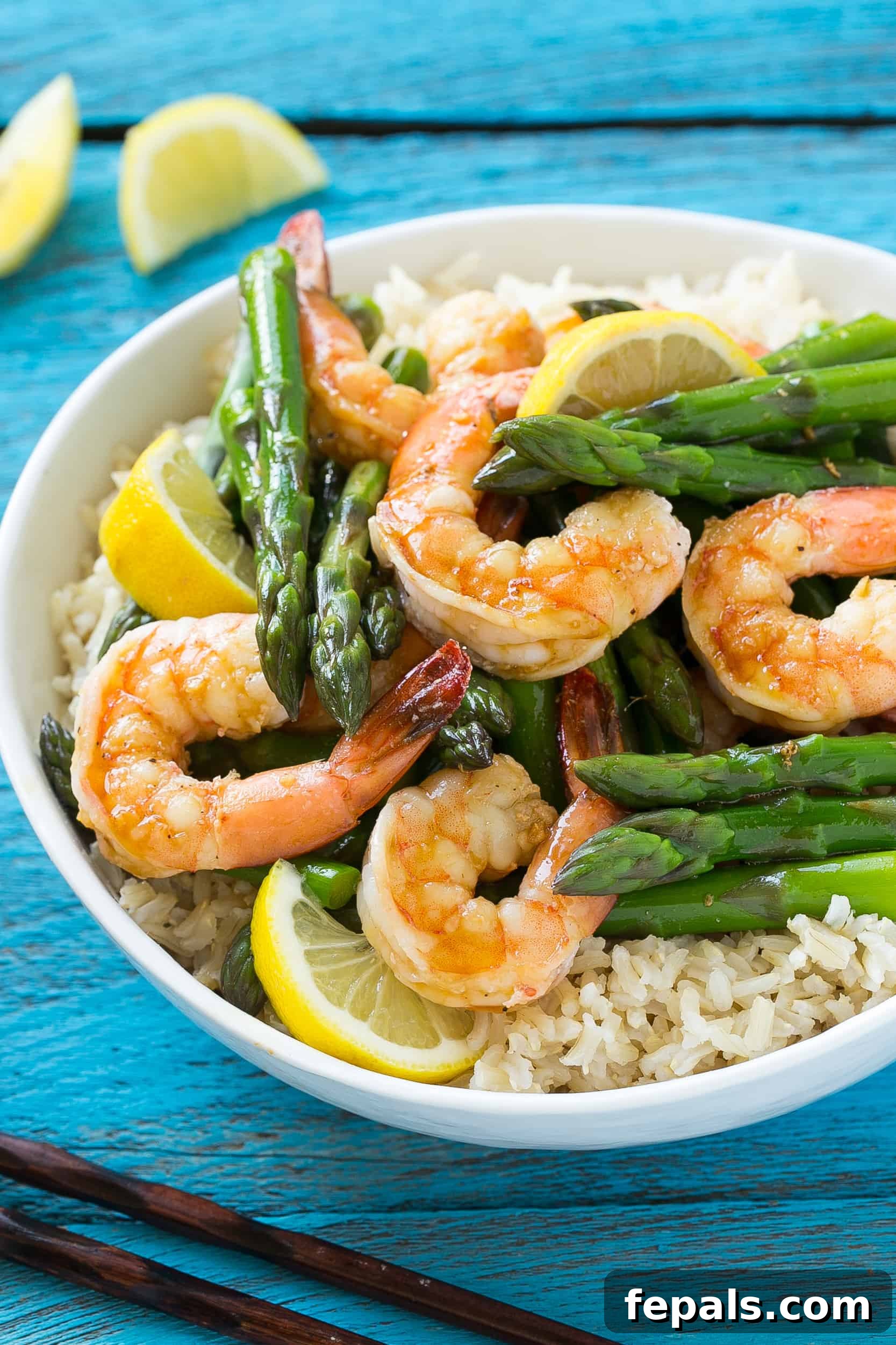 lemon ginger shrimp and asparagus in a bowl with rice