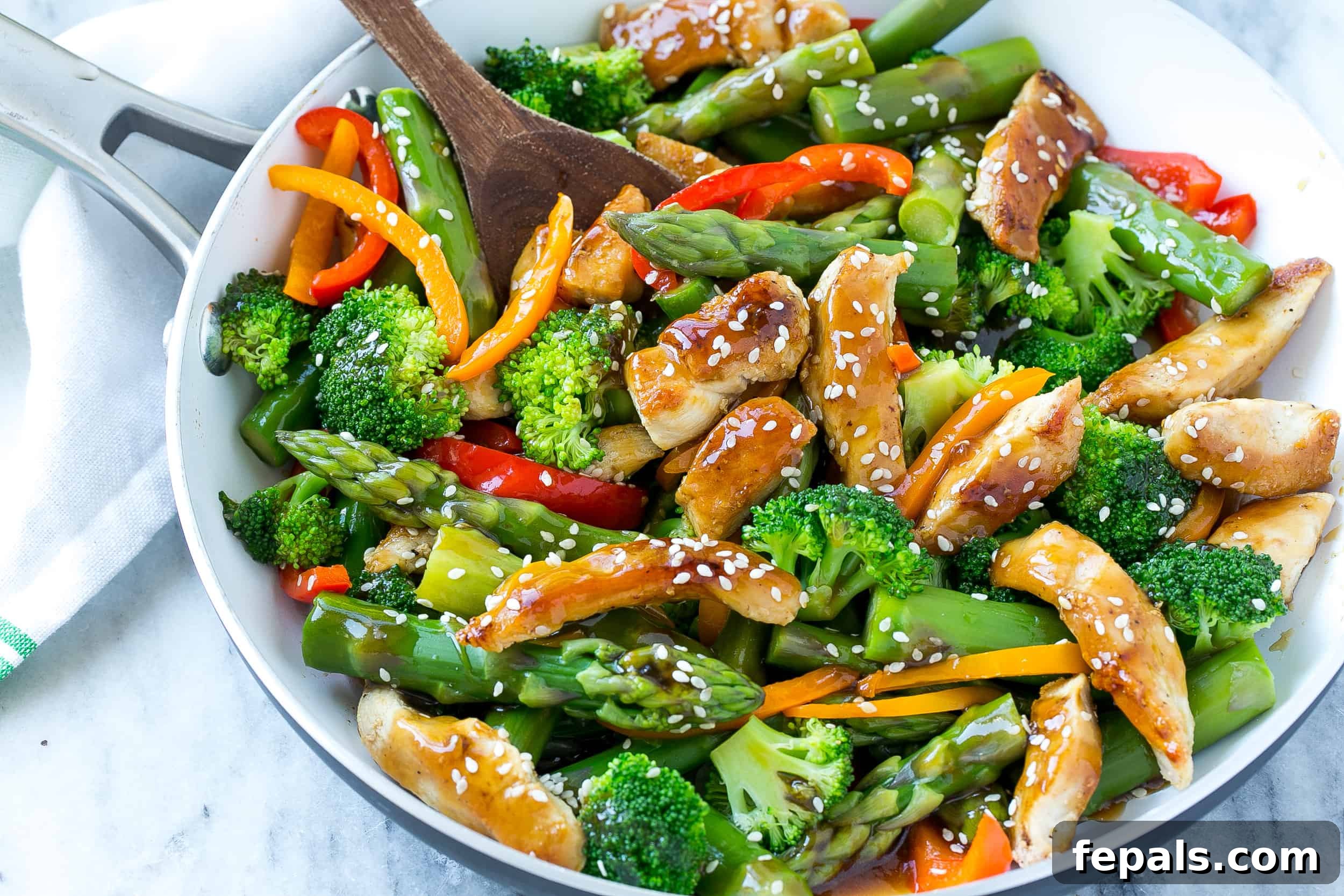 easy teriyaki recipe in skillet with sesame seeds