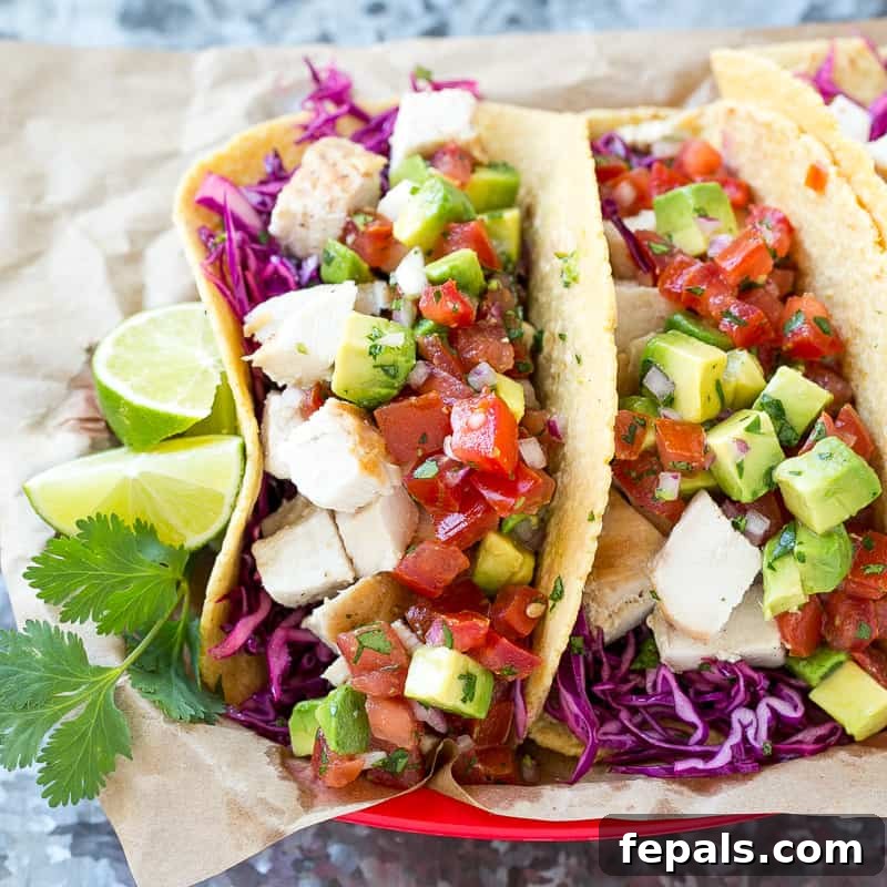 two Easy Chicken Tacos with lime on the side, garnished with cilantro