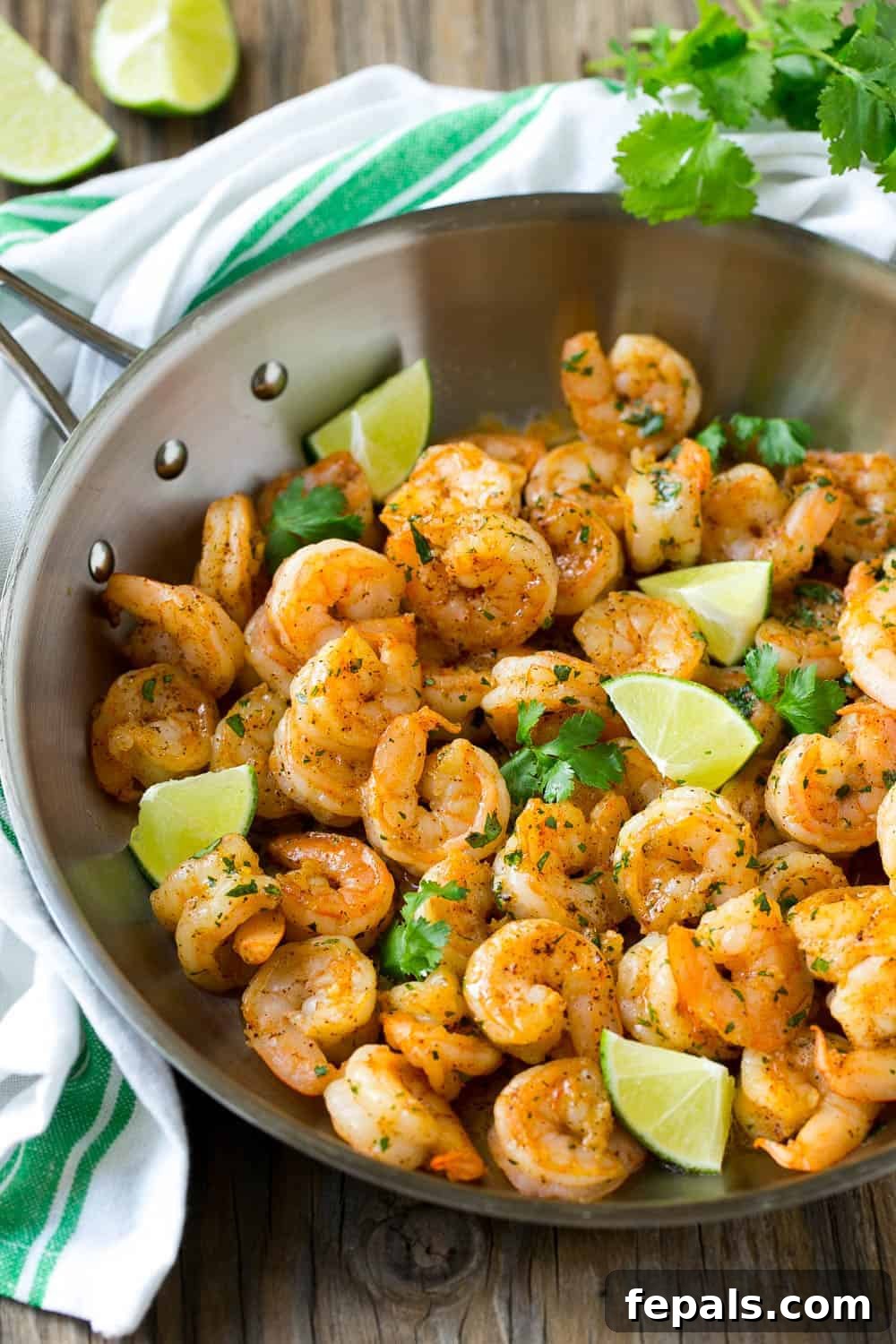 Flavorful Cilantro Lime Shrimp served with fresh herbs and lime wedges