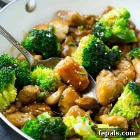 Wholesome Chicken and Broccoli Stir-Fry in Minutes 2 Chicken and Broccoli Stir Fry Recipe in pan with sauce and sesame seeds