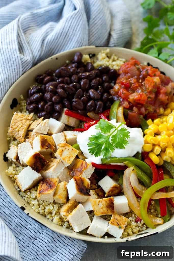 Close-up of a chicken and quinoa bowl with black beans, corn, and salsa