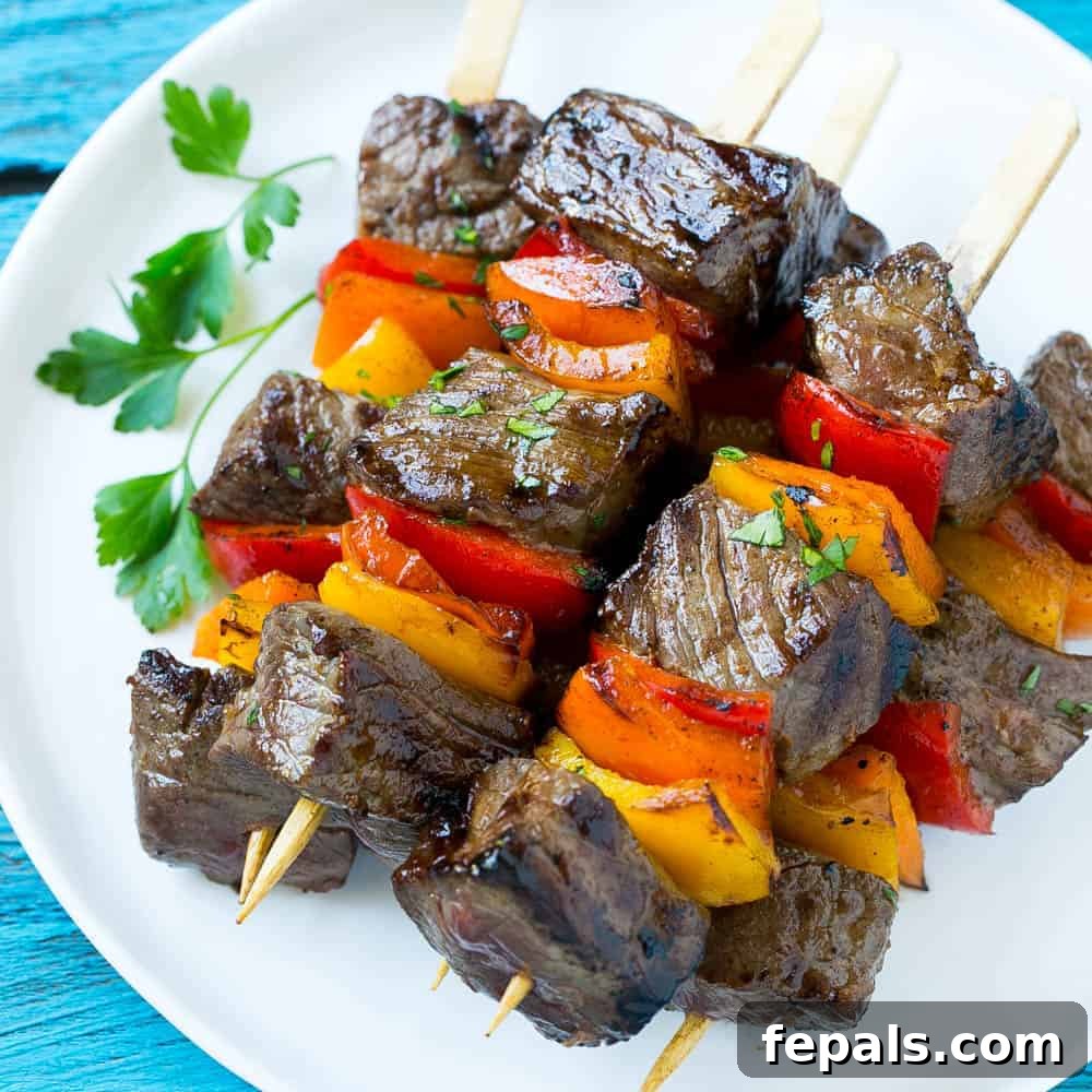 Juicy Grilled Steak Kabob Recipe Close-up of tender and juicy grilled steak kabobs, perfectly cooked.