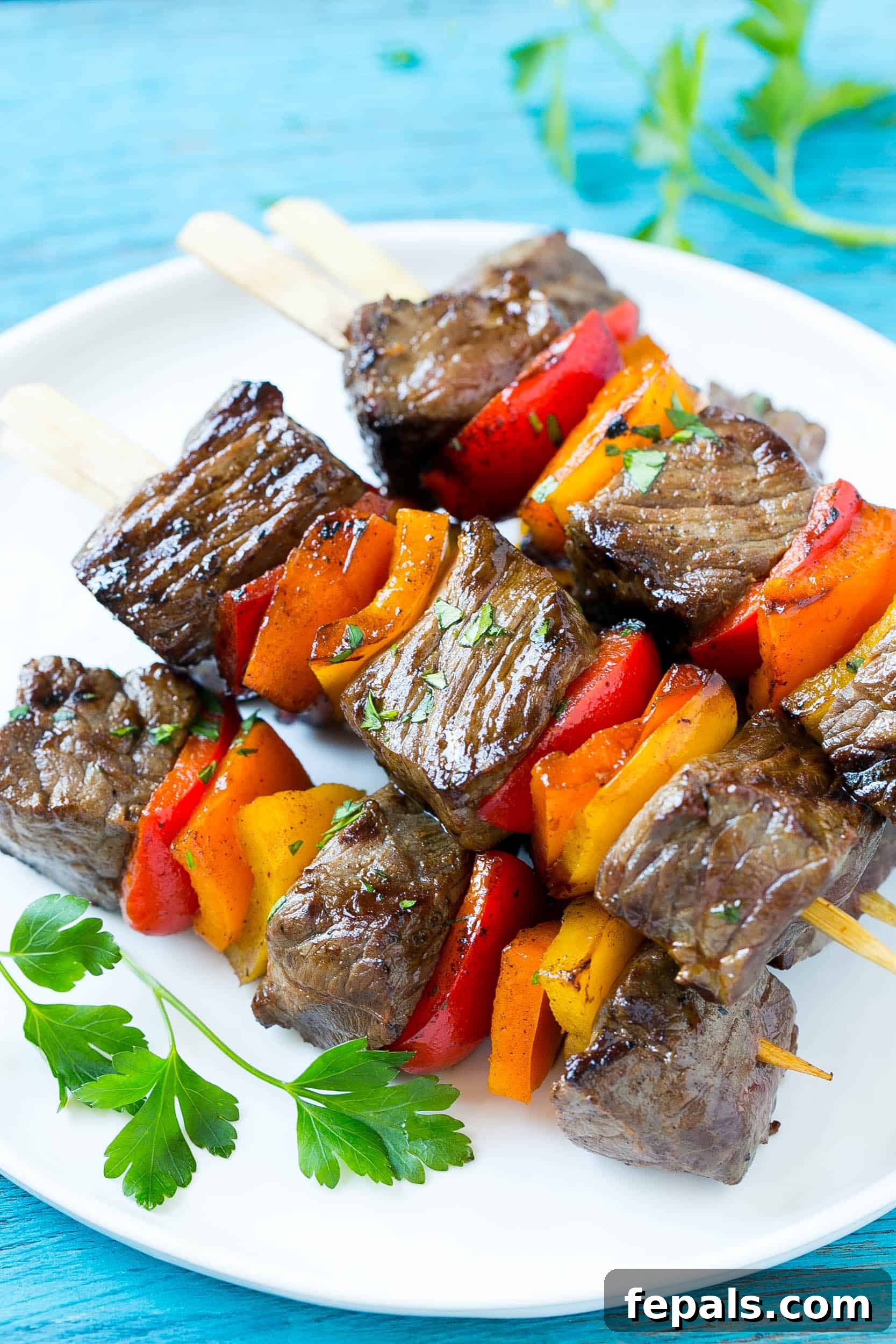Flavorful Grilled Kabob Recipe Delicious grilled pepper steak kabobs on a platter, garnished with fresh herbs.