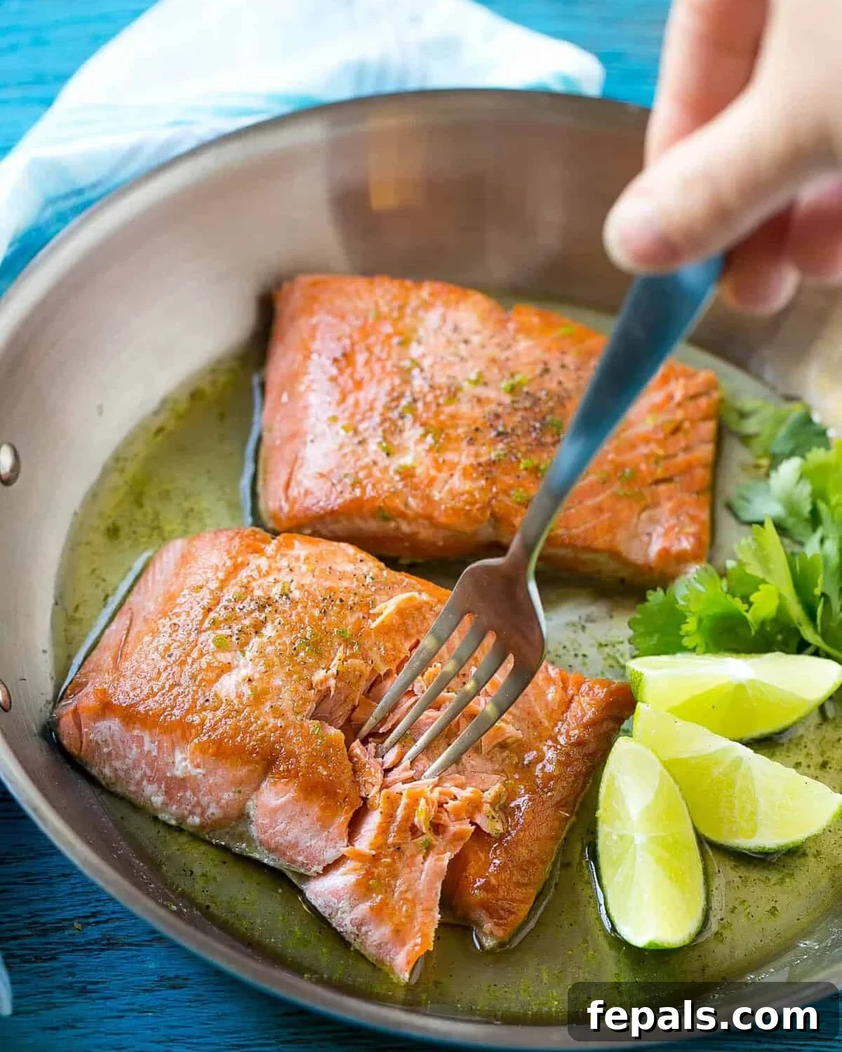 Sweet & Zesty Honey-Lime Salmon 5 Two glistening pan-seared salmon fillets coated in a honey-lime glaze, served in a skillet with fresh lime wedges.