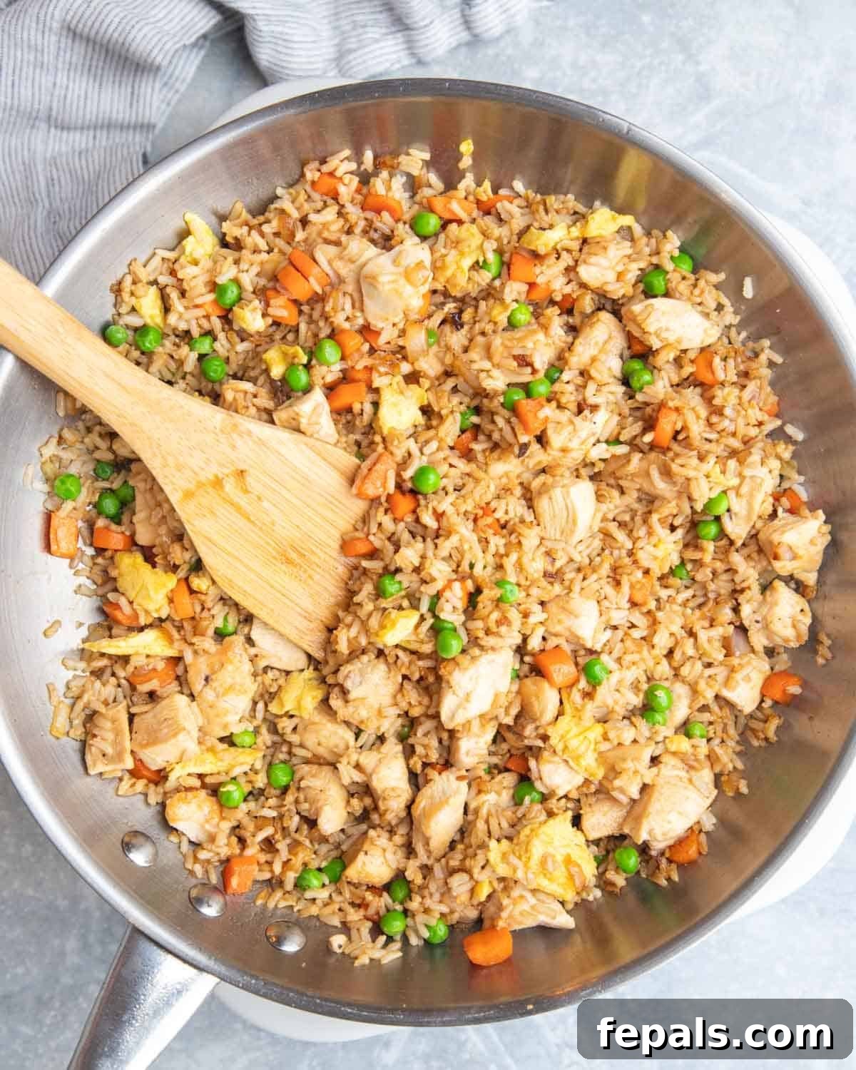 Classic Homemade Chicken Fried Rice 7 The finished chicken fried rice sizzling in a skillet, showcasing its vibrant colors and delicious texture.