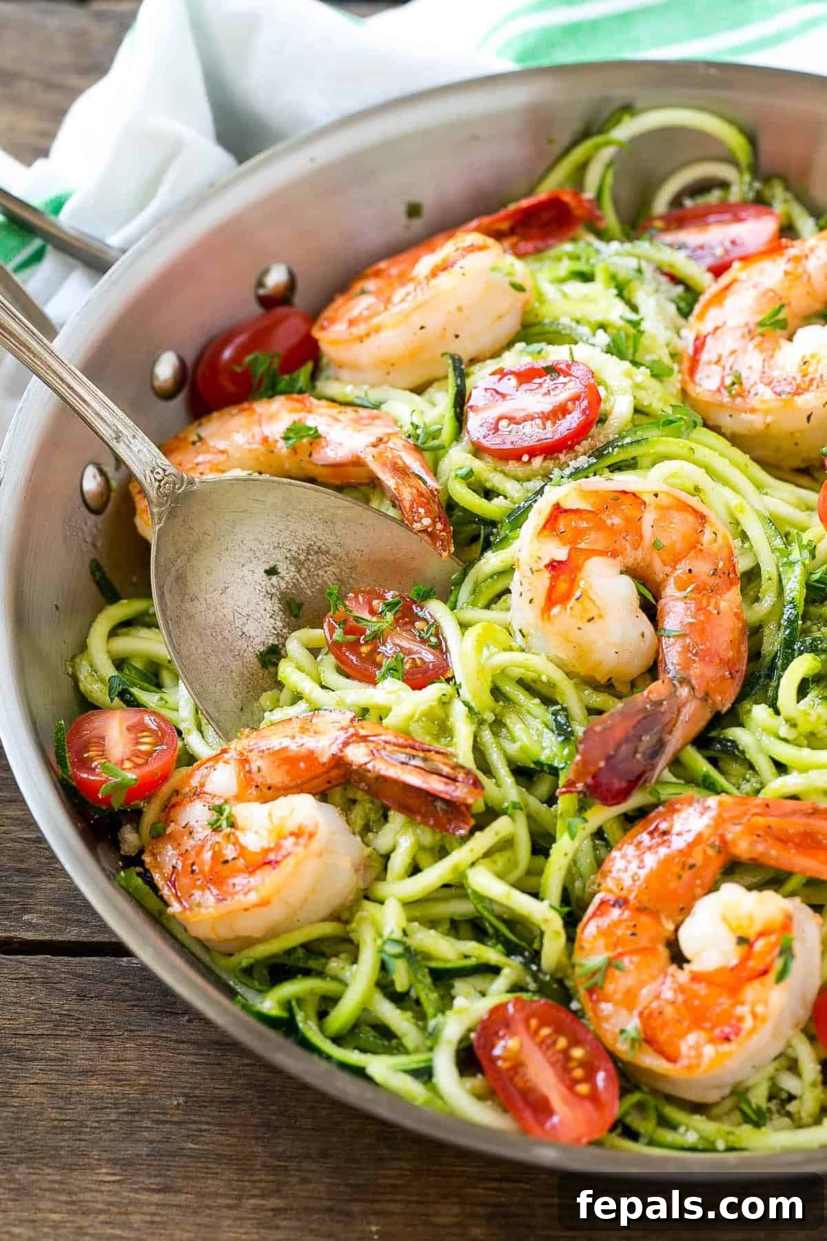 Vibrant Pesto Shrimp Zoodles 3 A serving of pesto zoodles with shrimp, ready to be enjoyed.