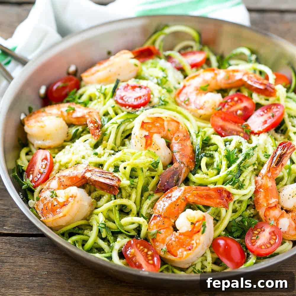Vibrant Pesto Shrimp Zoodles 5 Pesto Shrimp Zoodles in a pan, a vibrant and healthy meal idea.