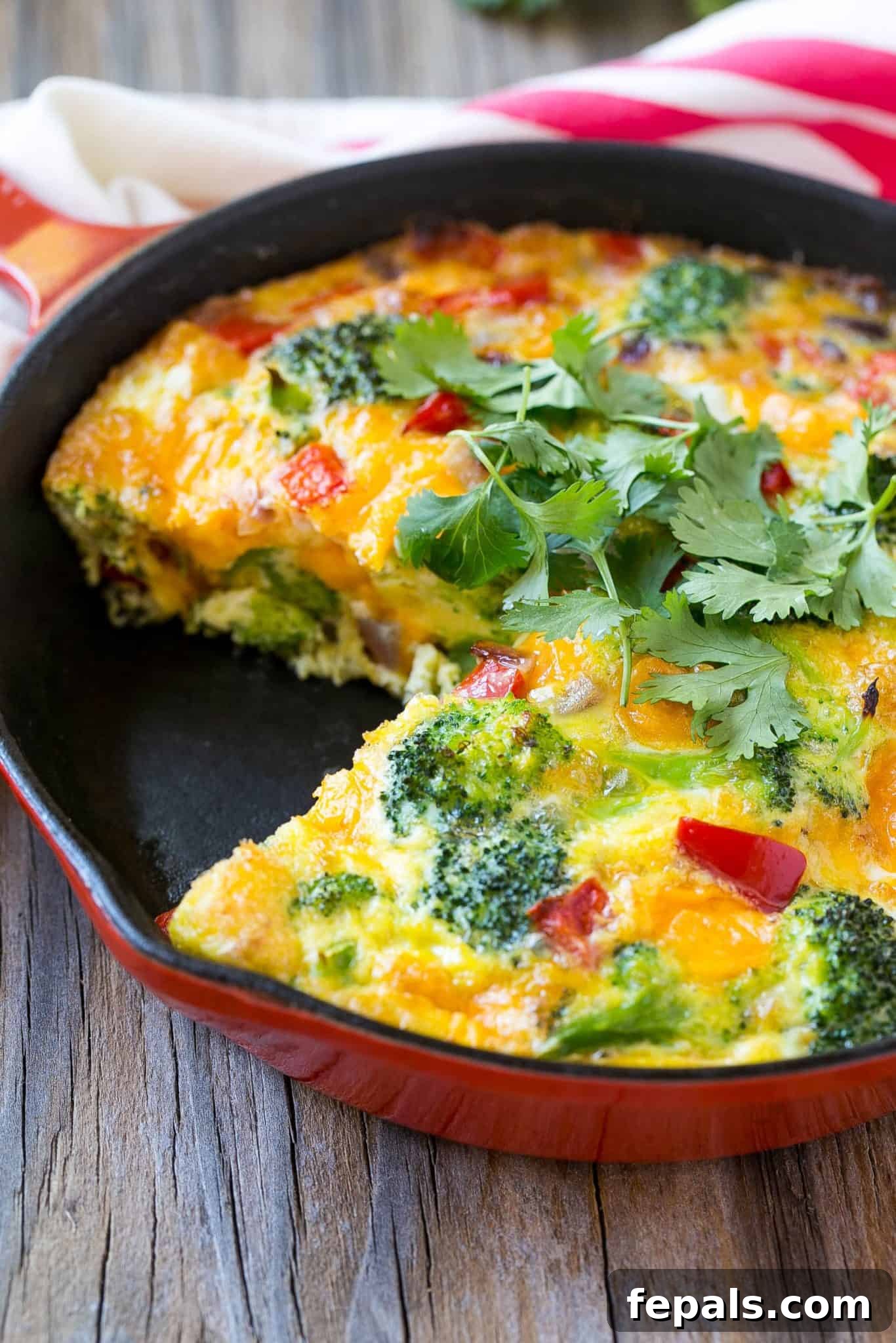 healthy vegetable frittata recipe baked breakfast skillet with cheese, piece cut out