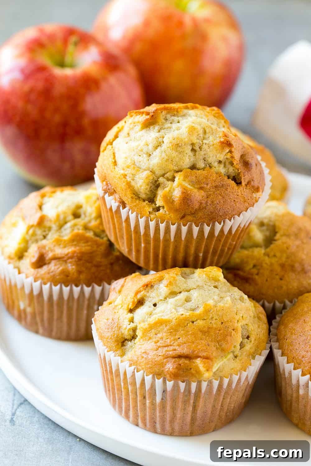 Power Apple Cinnamon Muffins 2 Freshly baked apple cinnamon muffins on a cooling rack, highlighting their golden brown tops and a hint of apple pieces