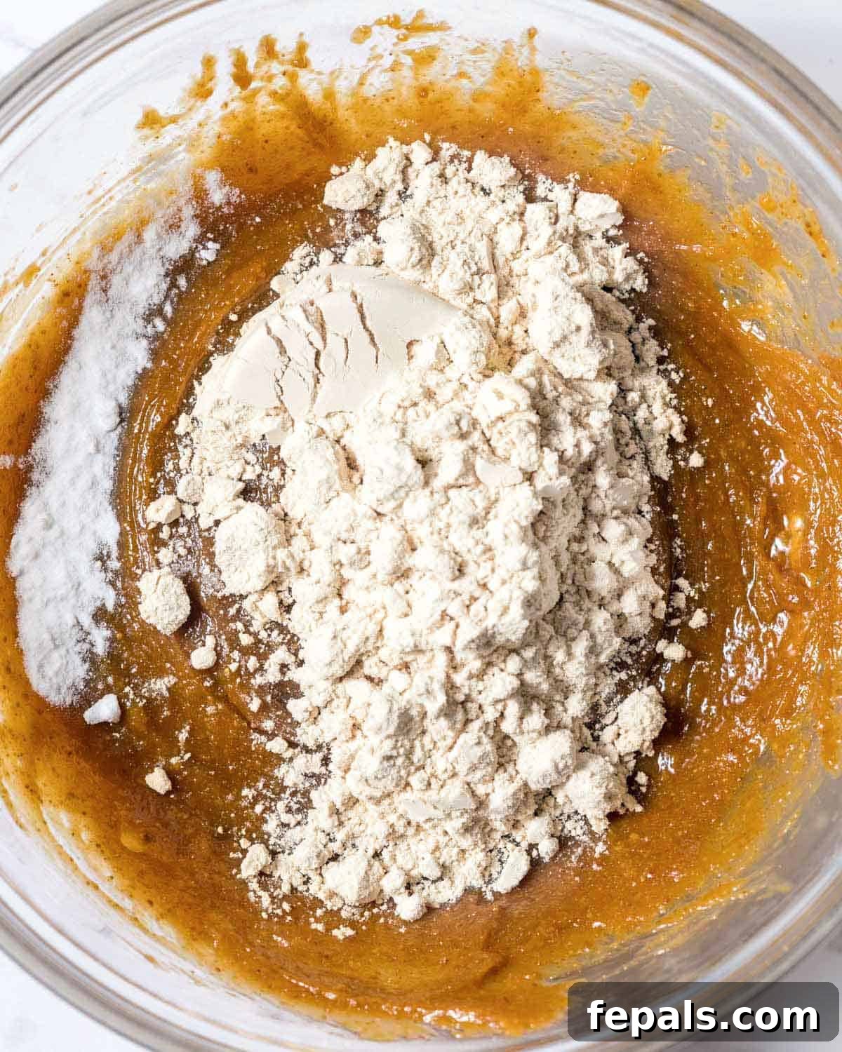 Power-Packed Protein Chocolate Cookies 7 Vanilla protein powder and baking soda added to the peanut butter dough in a bowl.