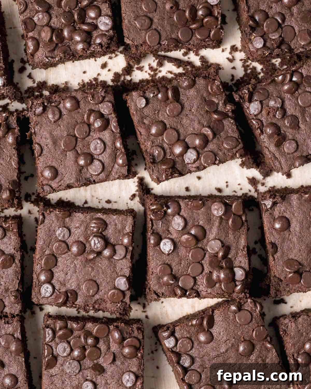 A beautiful arrangement of protein brownie squares placed side-by-side on a flat surface, highlighting their even cuts and enticing texture.