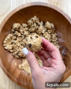 Hand holding a single ball of energy bites.