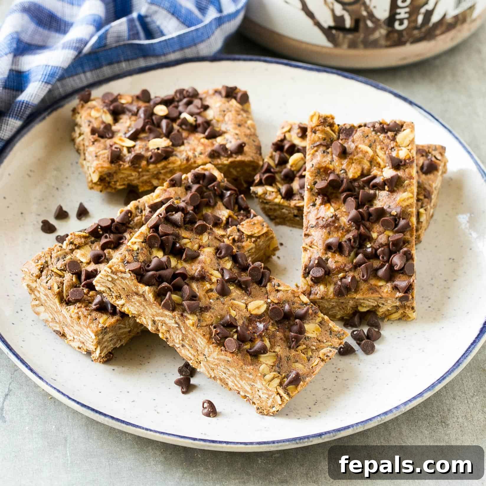 Homemade chocolate protein bars, perfectly sliced and ready to eat on a white plate.
