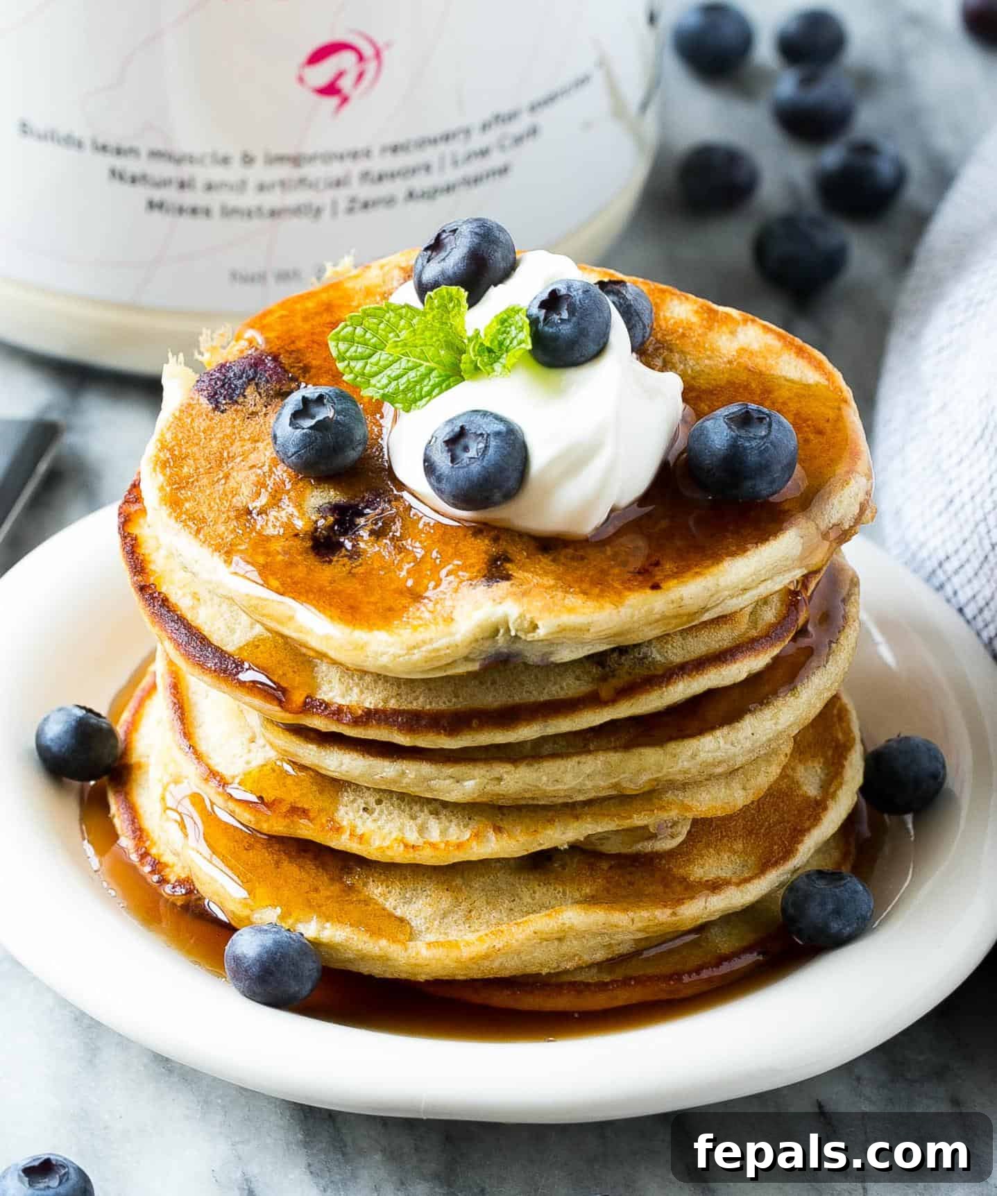 Easy protein pancakes with berries and a light drizzle of maple syrup