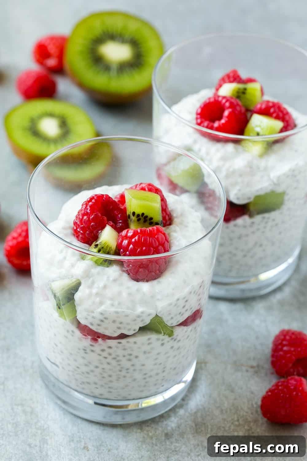 Creamy Coconut Chia Seed Pudding Easy Coconut Chia Pudding served in two glasses with fresh berries and kiwi