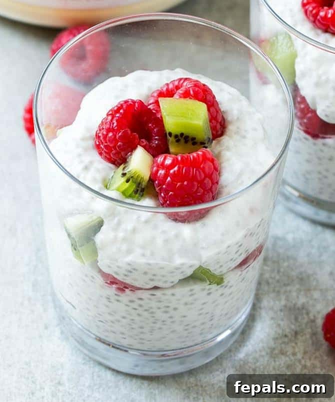 Refreshing Coconut Chia Pudding Coconut chia pudding served in a dish with fresh berries and a spoon