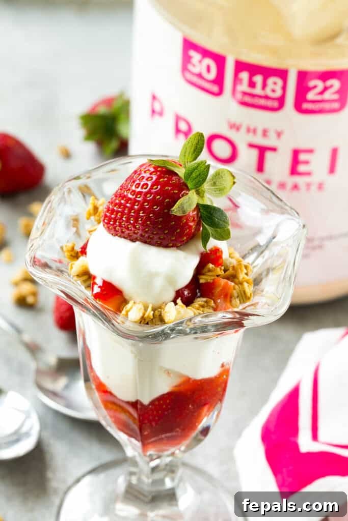 Strawberry Parfait Perfection 3 side shot of strawberry parfait in a jar next to a protein tub